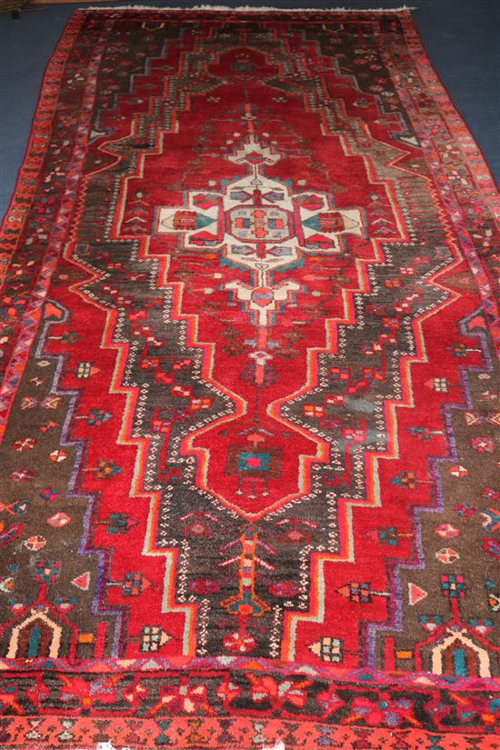 A Persian rug 310 x 155cm